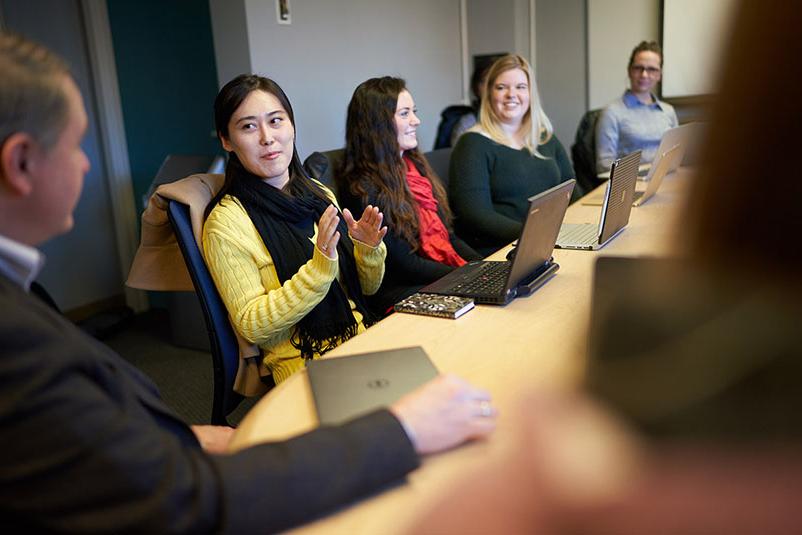 Industrial-Organizational Psychology students sit at a conference table